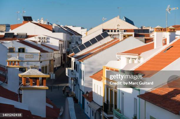 elevated view of a street and rooftops in the town of vila nova de milfontes along the rota vicentina in southwest portugal - alentejo stockfoto's en -beelden