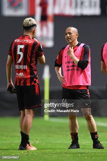 Shinji Ono and Akito Fukumori of Hokkaido Consadole Sapporo talk after the J.LEAGUE YBC Levain Cup Playoff Stage first leg between Hokkaido Consadole...