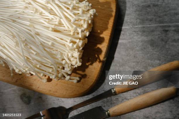 flammulina velutipes in the sun - enoki mushroom stock pictures, royalty-free photos & images