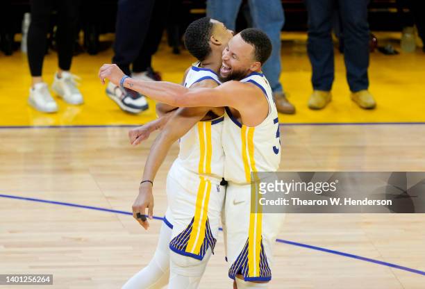 Jordan Poole and Stephen Curry of the Golden State Warriors react during the third quarter against the Boston Celtics in Game Two of the 2022 NBA...