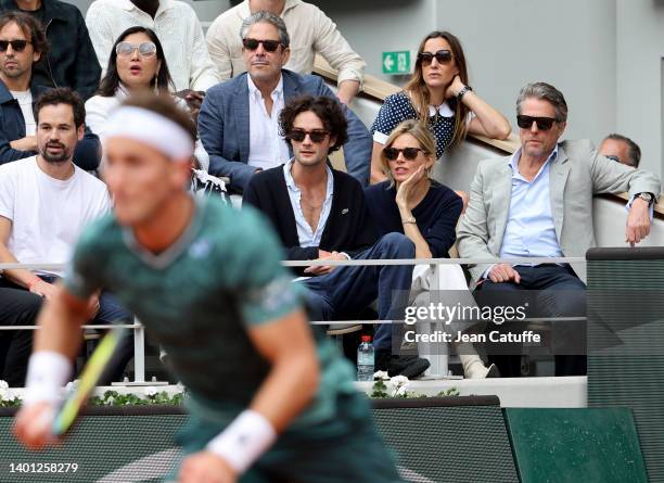 Oli Green, Sienna Miller, Hugh Grant, above him his wife Anna Elisabet Eberstein watching Casper Ruud of Norway attend the men's final on day 15 of...