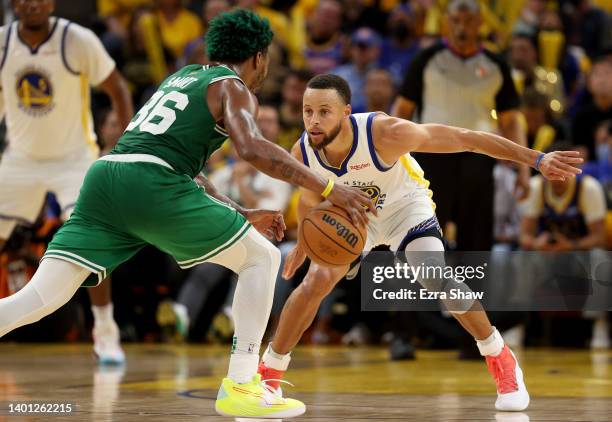 Stephen Curry of the Golden State Warriors guards Marcus Smart of the Boston Celtics during the third quarter in Game Two of the 2022 NBA Finals at...