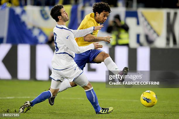Brazil's defender Marcelo scores his team's first goal against Bosnia's midfielder Miralem Pjanic during a friendly football match between...