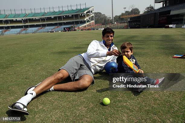 Delhi cricket player Ashish Nehra plays with his son Arush at Ferozshah Kotla Ground during Vijay Hazare Trophy, one day match between Delhi and...