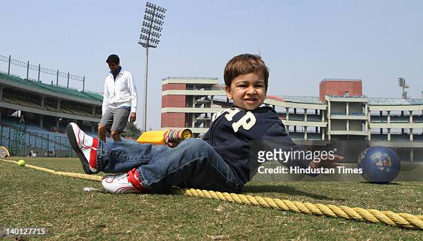 Delhi cricket player Ashish Nehra plays with his son Arush at Ferozshah Kotla Ground during Vijay Hazare Trophy, one day match between Delhi and...
