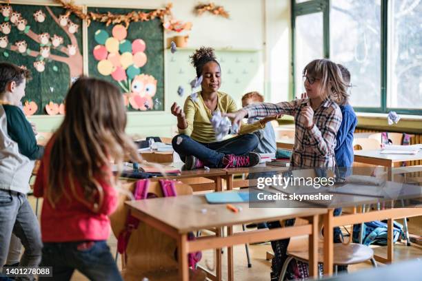 meditating in chaotic classroom! - naughty kids in classroom stock pictures, royalty-free photos & images