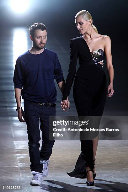 Anthony Vaccarello and Anja Rubik walk the runway during the Anthony Vaccarello Ready-To-Wear Fall/Winter 2012 show as part of Paris Fashion Week at...