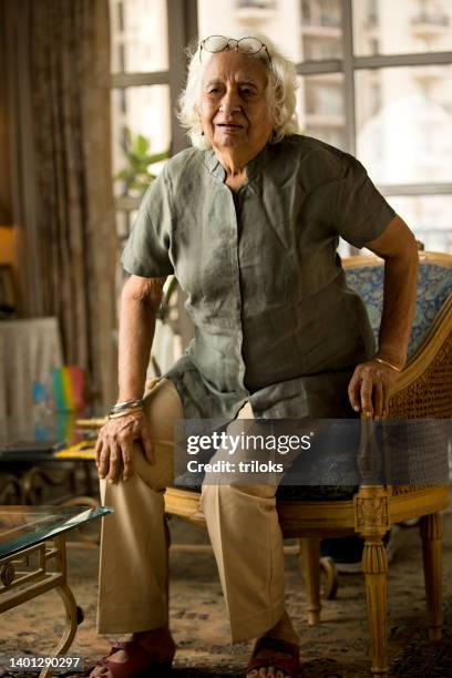 old woman holding her painful knee - weakness stock pictures, royalty-free photos & images