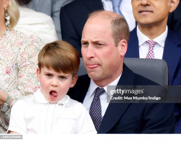 Prince Louis of Cambridge sits on his father Prince William, Duke of Cambridge's lap as they attend the Platinum Pageant on The Mall on June 5, 2022...