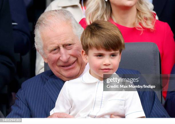 Prince Louis of Cambridge sits on his grandfather Prince Charles, Prince of Wales's lap as they attend the Platinum Pageant on The Mall on June 5,...