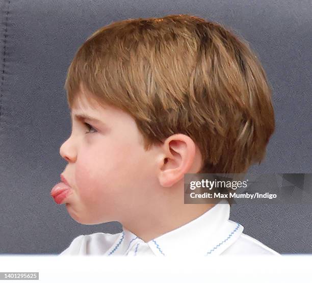 Prince Louis of Cambridge sticks his tongue out at his mother Catherine, Duchess of Cambridge as they attend the Platinum Pageant on The Mall on June...