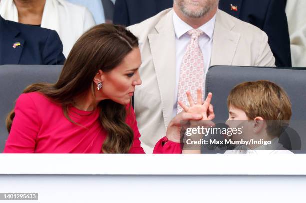 Prince Louis of Cambridge 'thumb's his nose' and sticks his tongue out at his mother Catherine, Duchess of Cambridge as they attend the Platinum...