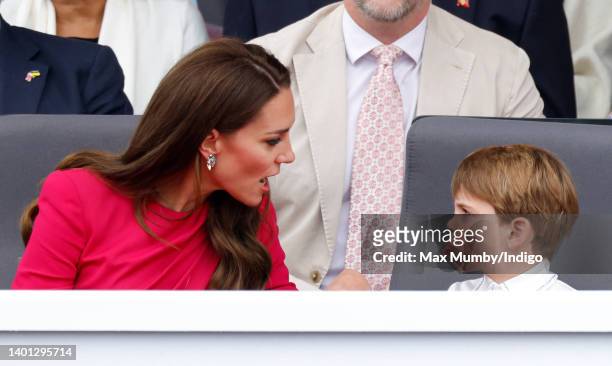 Prince Louis of Cambridge sticks his tongue out at his mother Catherine, Duchess of Cambridge as they attend the Platinum Pageant on The Mall on June...