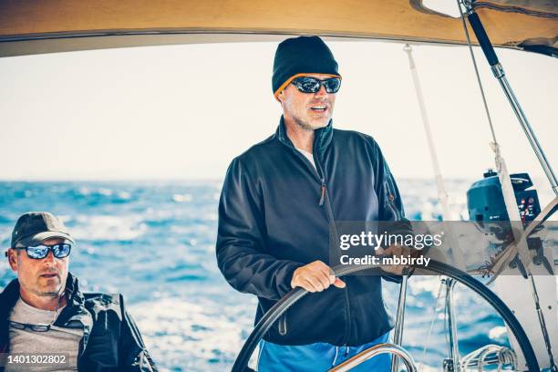 skipper on sailboat - captain yacht stock pictures, royalty-free photos & images