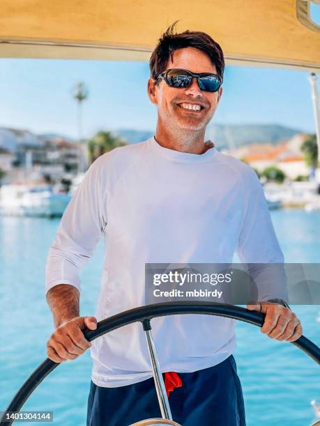 skipper on sailboat - captain yacht stock pictures, royalty-free photos & images