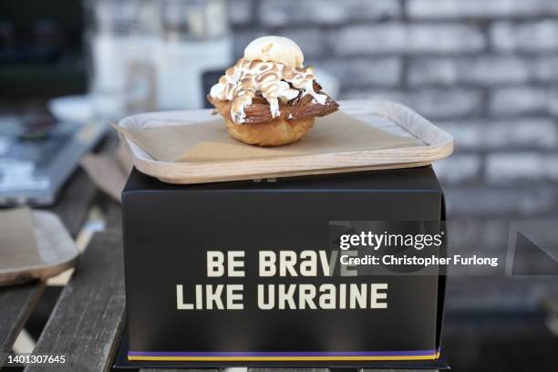 In this photo illustration a cake named after British Prime Minister Boris Johnson sits on top of a take-away box at the Zavertailo Cafe, one of...