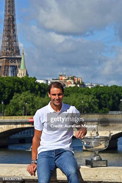 Rafael Nadal of Spain poses with the Musketeers trophy after winning his 14th Roland Garros Grand Chelem tournament on Alexander the 3rd bridge on...