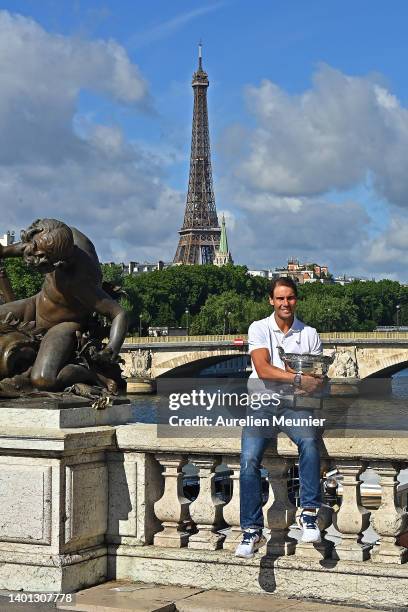 Rafael Nadal of Spain poses with the Musketeers trophy after winning his 14th Roland Garros Grand Chelem tournament on Alexander the 3rd bridge on...