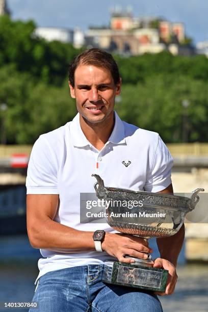 Rafael Nadal of Spain poses with the Musketeers trophy after winning his 14th Roland Garros Grand Chelem tournament on Alexander the 3rd bridge on...