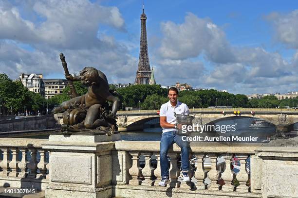 Rafael Nadal of Spain poses with the Musketeers trophy after winning his 14th Roland Garros Grand Chelem tournament on Alexander the 3rd bridge on...