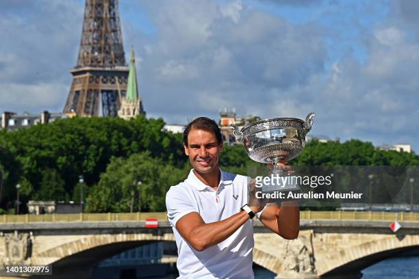 Rafael Nadal of Spain poses with the Musketeers trophy after winning his 14th Roland Garros Grand Chelem tournament on Alexander the 3rd bridge on...