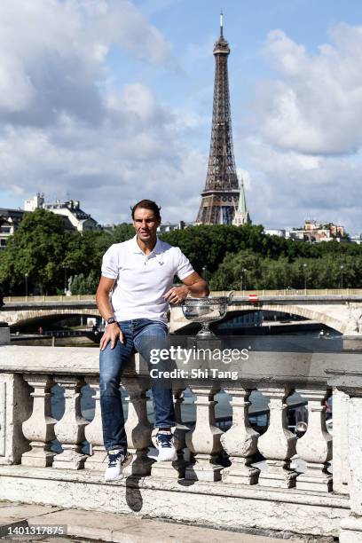 Rafael Nadal of Spain poses with the Musketeers trophy after winning his 14th Roland Garros Grand Slam tournament on Alexander the 3rd bridge on June...