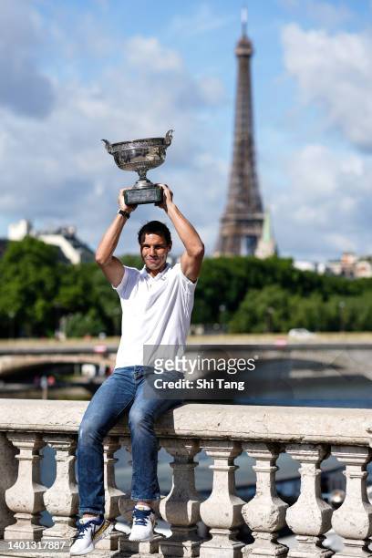 Rafael Nadal of Spain poses with the Musketeers trophy after winning his 14th Roland Garros Grand Slam tournament on Alexander the 3rd bridge on June...