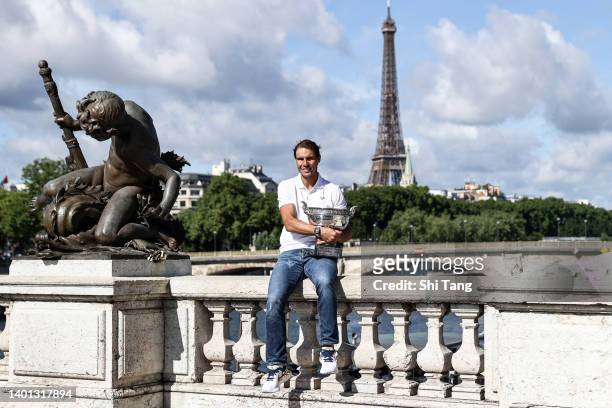 Rafael Nadal of Spain poses with the Musketeers trophy after winning his 14th Roland Garros Grand Slam tournament on Alexander the 3rd bridge on June...