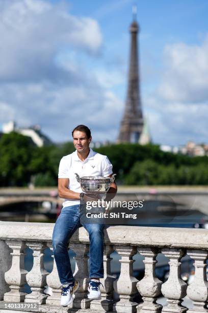 Rafael Nadal of Spain poses with the Musketeers trophy after winning his 14th Roland Garros Grand Slam tournament on Alexander the 3rd bridge on June...