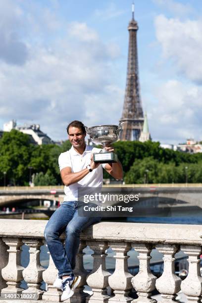 Rafael Nadal of Spain poses with the Musketeers trophy after winning his 14th Roland Garros Grand Slam tournament on Alexander the 3rd bridge on June...