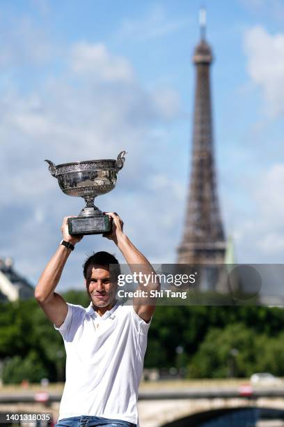 Rafael Nadal of Spain poses with the Musketeers trophy after winning his 14th Roland Garros Grand Slam tournament on Alexander the 3rd bridge on June...