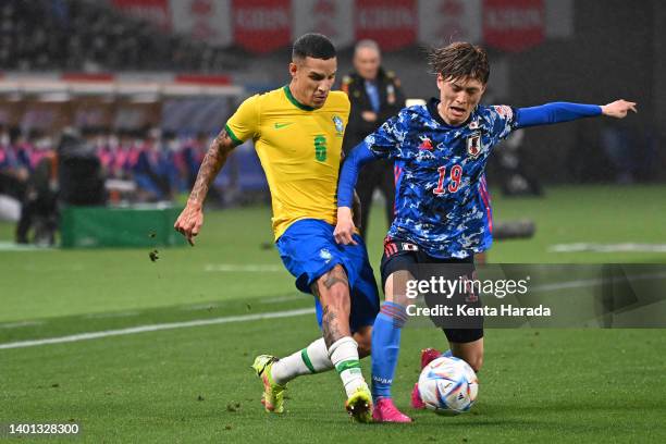 Guilherme Arana of Brazil and Kyogo Furuhashi of Japan compete for the ball during the international friendly match between Japan and Brazil at...