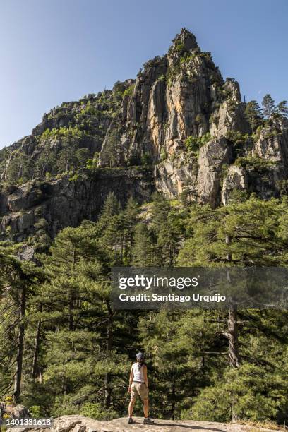 woman exploring the rock formations in restonica valley - corsica france stock pictures, royalty-free photos & images