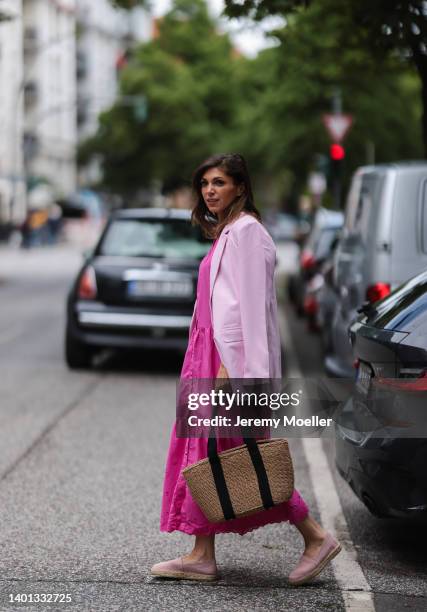 Anna Wolfers seen wearing a light pink blazer, a pink maxi dress with long sleeves, a bast basket shopper bag and light pink espadrilles on June 02,...