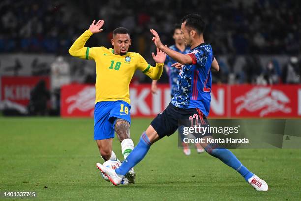 Gabriel Jesus of Brazil and Maya Yoshida of Japan compete for the ball during the international friendly match between Japan and Brazil at National...