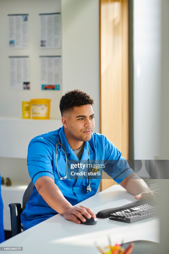 Junior doctor writing up his notes