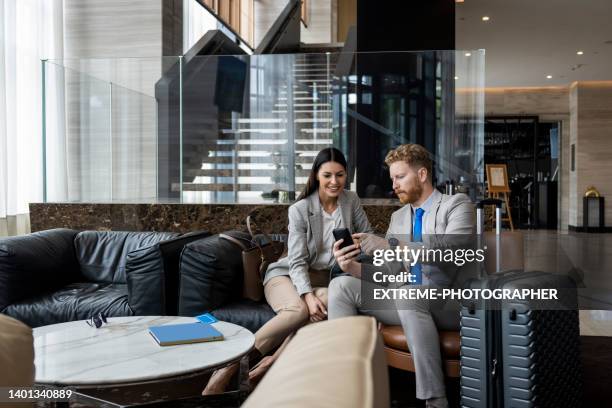 hotel experience of two young colleagues - business travel stock pictures, royalty-free photos & images