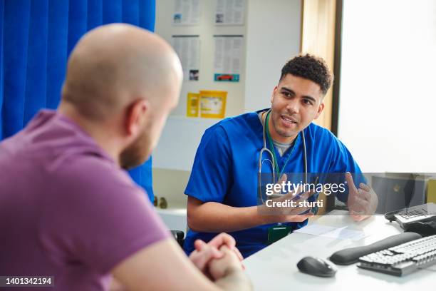 hospital doctor explaining to patient - man talking to doctor bildbanksfoton och bilder