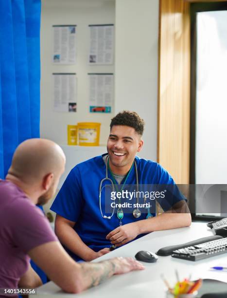happy junior doctor with patient - nhs stock pictures, royalty-free photos & images