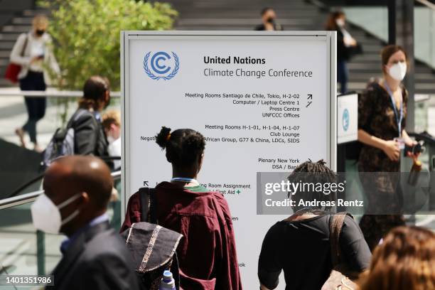 Participants look at a notice board on Climate Change on the opening day of the UNFCCC's SB56 climate conference on June 06, 2022 in Bonn, Germany....