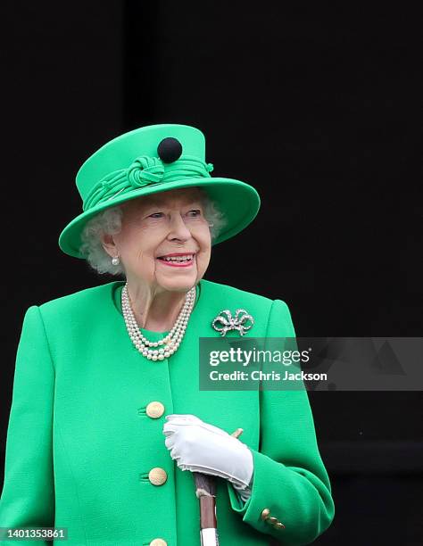 Queen Elizabeth II waves from the balcony of Buckingham Palace during the Platinum Jubilee Pageant on June 05, 2022 in London, England. The Platinum...