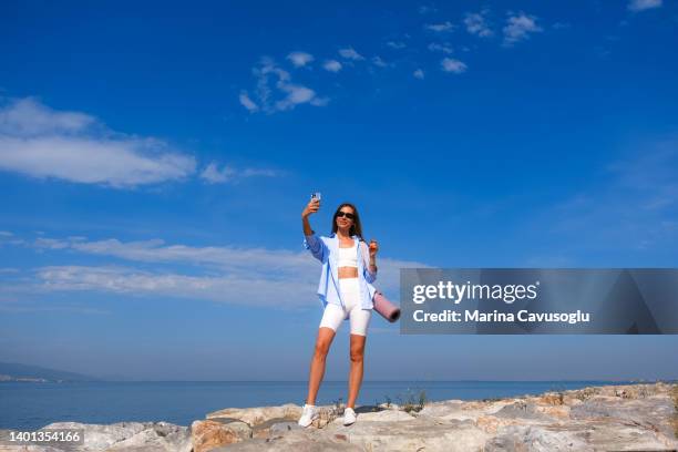 Young Woman In Sport Outfit Making Selfie At The Sea High-Res Stock Photo