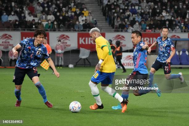 Neymar Jr. Of Brazil controls the ball under pressure of Ko Itakura and Yuto Nagatomo of Japan during the international friendly match between Japan...