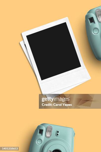 stack of blank instant print transfer with instant camera in yellow - film collector stock pictures, royalty-free photos & images