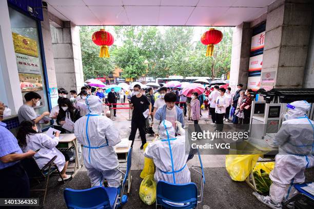 Senior three students queue up for COVID-19 nucleic acid tests at a high school ahead of national college entrance exam on June 6, 2022 in Shenyang,...