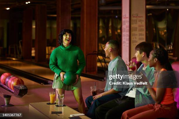 woman holding ball talking with friends - ten pin bowling foto e immagini stock