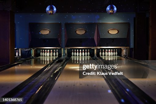 Bowling pins arranged on tracks at alley Bowling pins arranged on tracks at alley