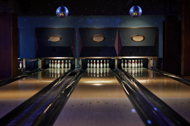bowling pins arranged on tracks at alley - bowling stock pictures, royalty-free photos & images