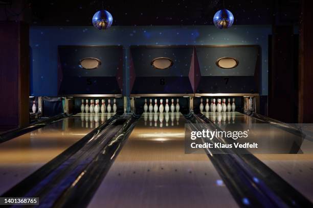 bowling pins arranged on tracks at alley - bowling alley stock pictures, royalty-free photos & images