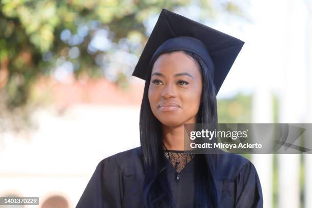 Portrait Of A Happy African American Woman With Her Thumbs Up Wearing A Black Graduation Cap And Gown In An Public Park High-Res Stock Photo - Getty Images Portrait Of A Happy African American Woman With Her Thumbs Up Wearing A Black Graduation Cap And Gown In An Public Park High-Res Stock Photo - Getty Images